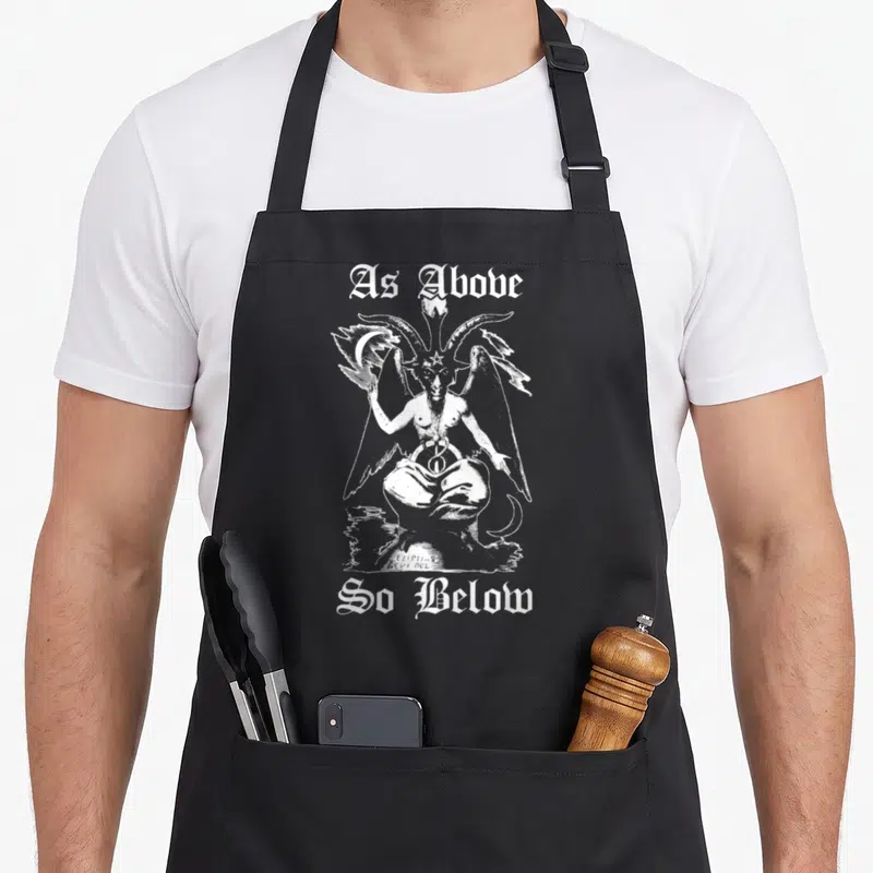 Above magic apron - White line art demon with As Above So Below text and signature — shown on a black cotton canvas apron against a white background