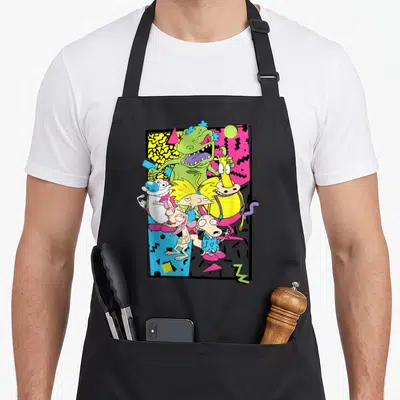 Nick 90s apron - Ren and Stimpy characters in Memphis geometric frame with pink yellow green blue shapes — shown on a black cotton canvas apron against a white background