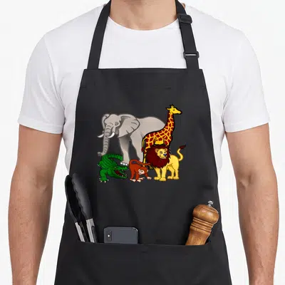 Safari animal apron - Cartoon grey elephant yellow giraffe red spotted lion brown monkey green crocodile illustration — shown on a black cotton canvas apron against a white background