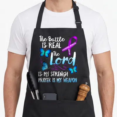 Rheumatoid ribbon apron - Purple ribbon and three blue butterflies surrounding stacked white and blue text about — shown on a black cotton canvas apron against a white background