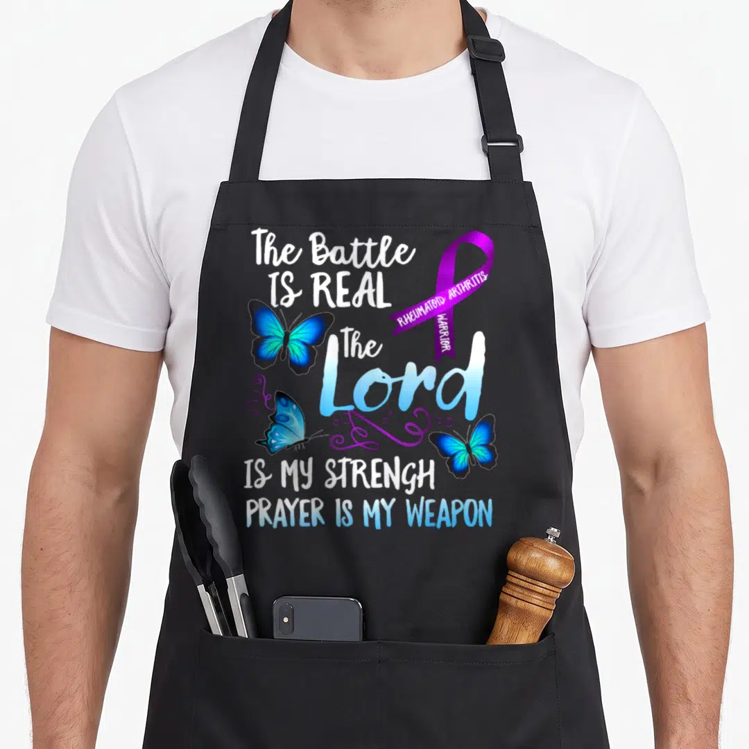 Rheumatoid ribbon apron - Purple ribbon and three blue butterflies surrounding stacked white and blue text about — shown on a black cotton canvas apron against a white background