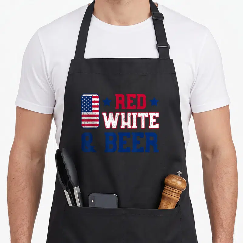 Funny beer 4th of july apron - Distressed red white and blue beer can with flag pattern and stacked text reading RED — shown on a black cotton canvas apron against a white background