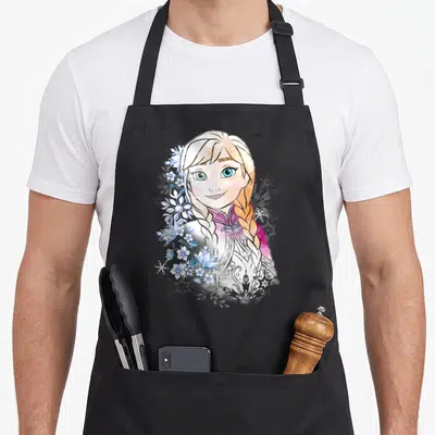Illustrated frozen apron - Watercolor Elsa portrait with blue flowers and snowflakes on white and purple — shown on a black cotton canvas apron against a white background