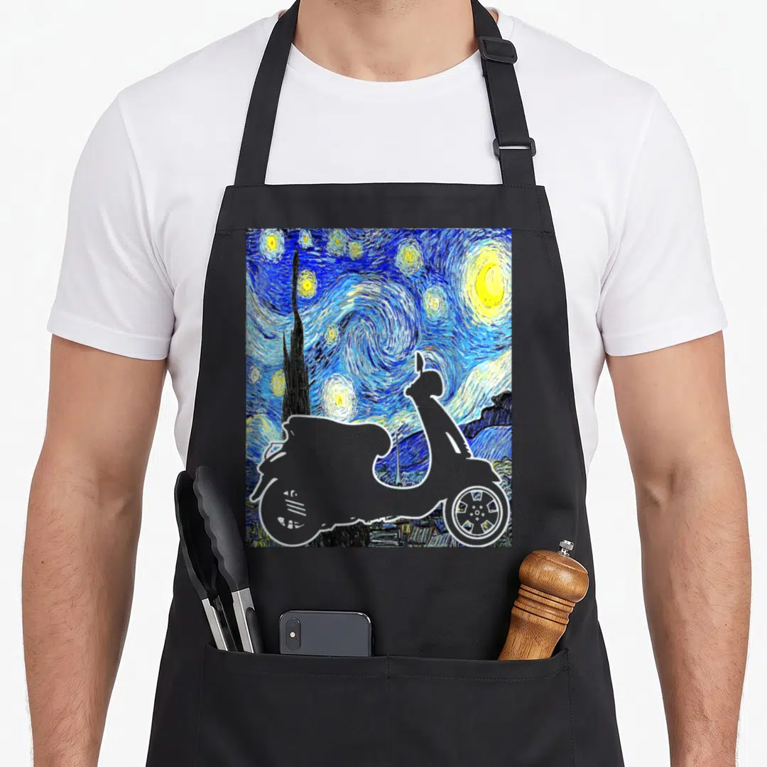 Moped van gogh apron - Grey scooter silhouette overlaid on blue and yellow starry night painting swirls — shown on a black cotton canvas apron against a white background