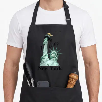 Elegant new york apron - Statue of Liberty photo with I love New York text in teal gold and black — shown on a black cotton canvas apron against a white background