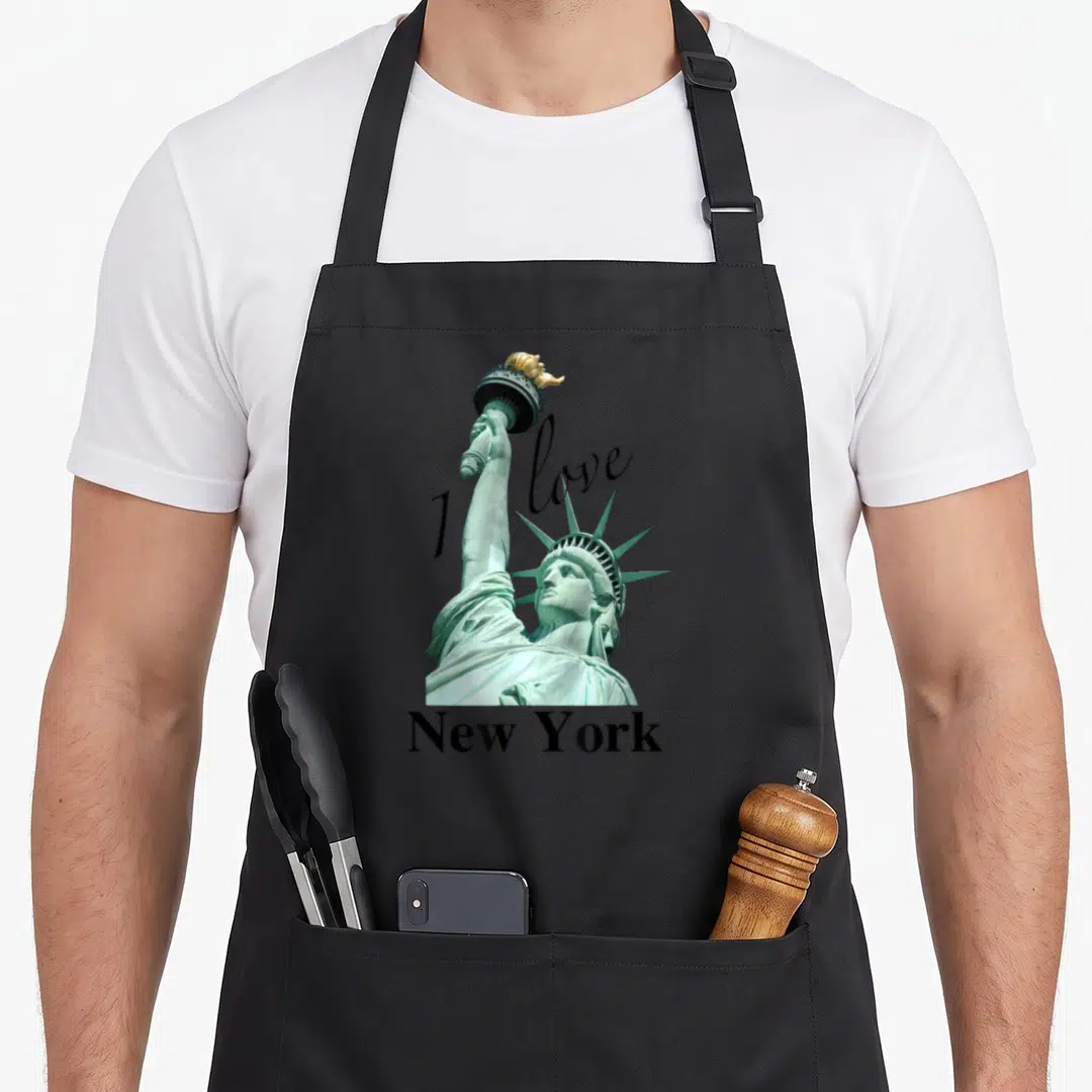 Elegant new york apron - Statue of Liberty photo with I love New York text in teal gold and black — shown on a black cotton canvas apron against a white background