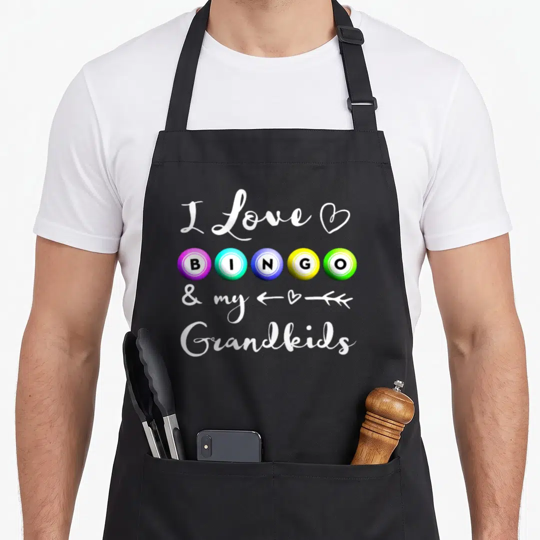 Bingo nana aprons - I Love BINGO & my Grandkids text with purple blue yellow green balls and white script — shown on a black cotton canvas apron against a white background