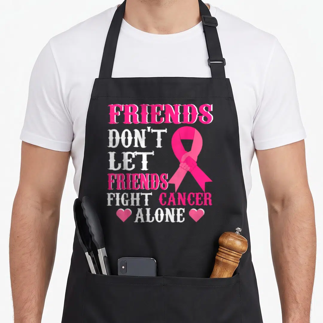 Friend breast cancer awareness aprons - Pink ribbon with shaking hands and stacked text FRIENDS DON'T LET FRIENDS FIGHT — shown on a black cotton canvas apron against a white background