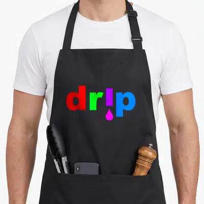 Dripping drip apron - Colorful drip text with pink droplet under i, no images — shown on a black cotton canvas apron against a white background