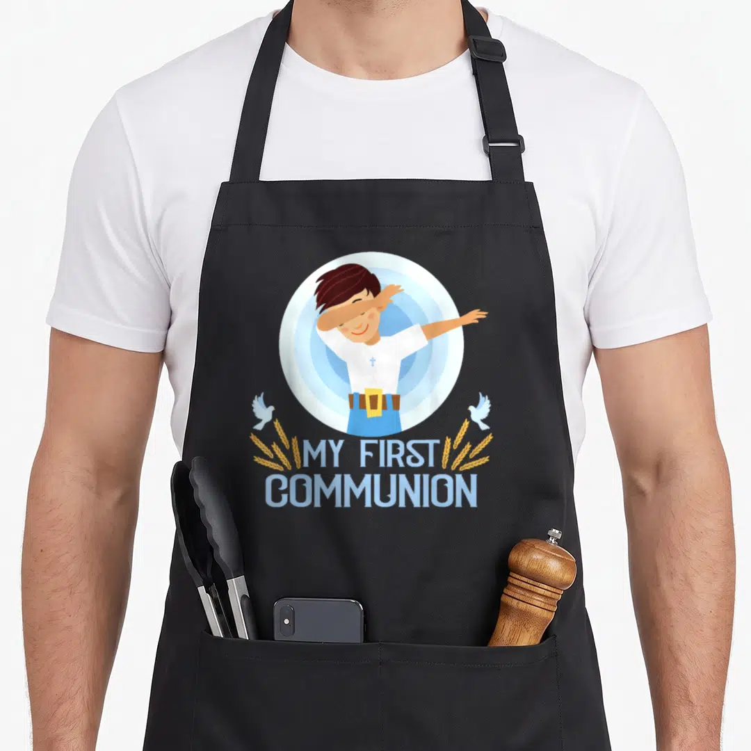 Dabbing communion aprons - Cartoon boy dabbing inside blue circle with white doves and yellow wheat stalks below — shown on a black cotton canvas apron against a white background