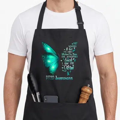 Ptsd butterfly apron - Teal watercolor butterfly with PTSD awareness poem and ribbon icons — shown on a black cotton canvas apron against a white background