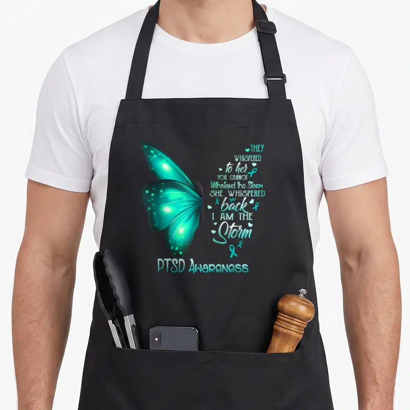 Ptsd butterfly apron - Teal watercolor butterfly with PTSD awareness poem and ribbon icons — shown on a black cotton canvas apron against a white background