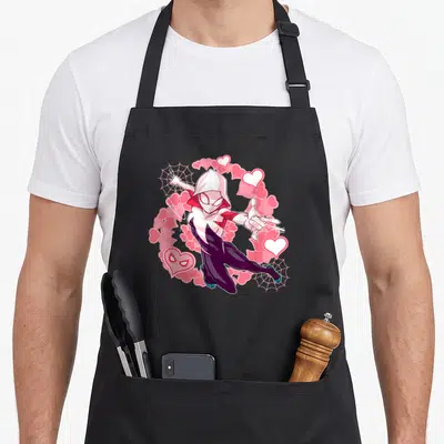 Spider animal apron - Hooded superhero with pink hearts and two spider webs in cartoon style — shown on a black cotton canvas apron against a white background