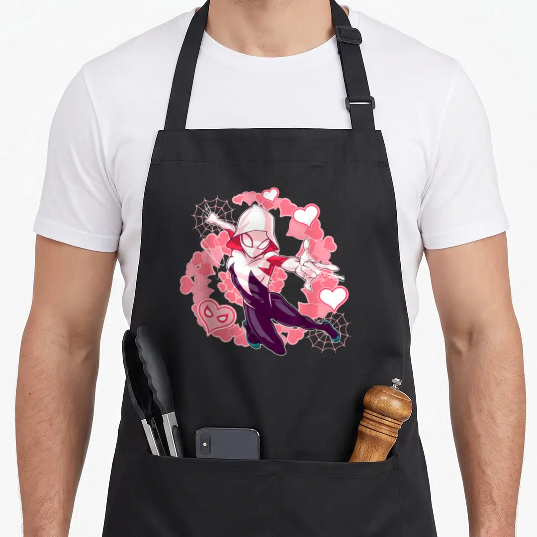 Spider animal apron - Hooded superhero with pink hearts and two spider webs in cartoon style — shown on a black cotton canvas apron against a white background