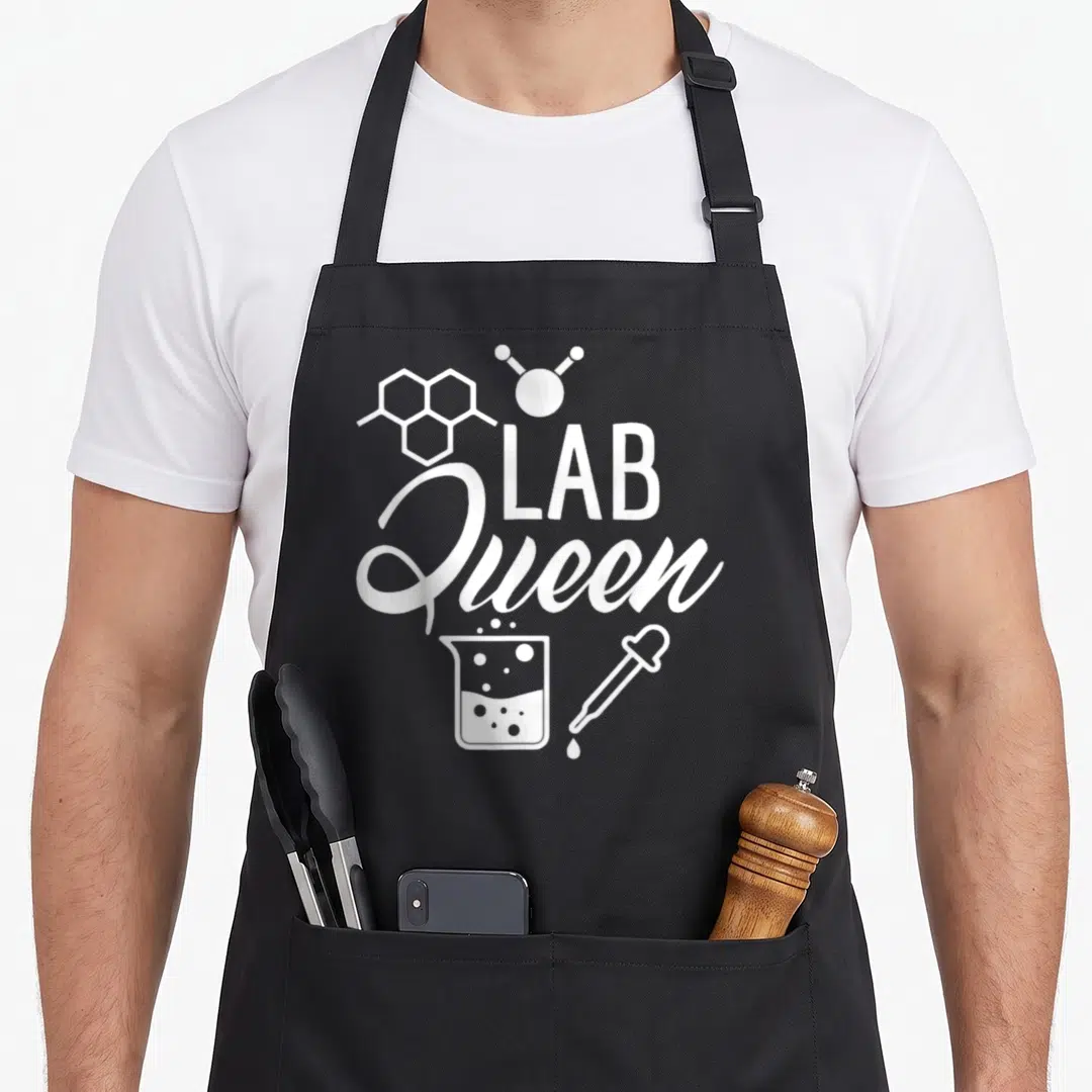 Queen laboratory apron - White Lab Queen text with molecule, beaker, and dropper graphics — shown on a black cotton canvas apron against a white background