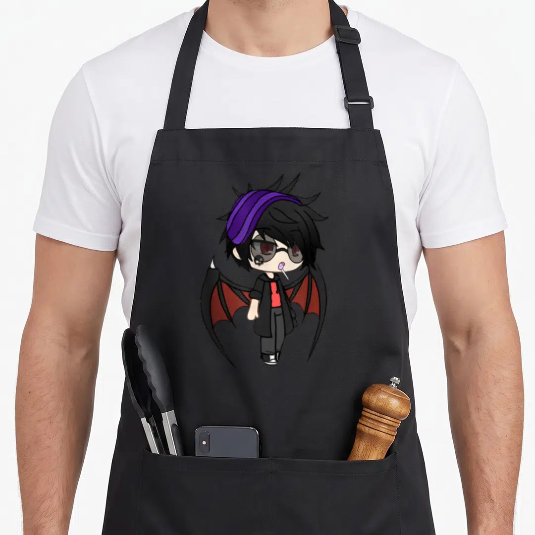 Vamp kawaii cooking apron - Chibi vampire character with bat wings, purple headband, glasses, and lollipop in goth — shown on a black cotton canvas apron against a white background