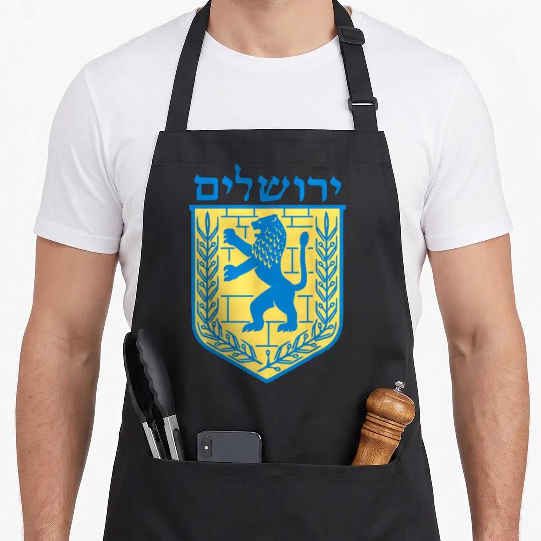 Lion jewish aprons - Blue and yellow shield with lion, wall, olive branches, and Hebrew text reading Jerusalem — shown on a black cotton canvas apron against a white background