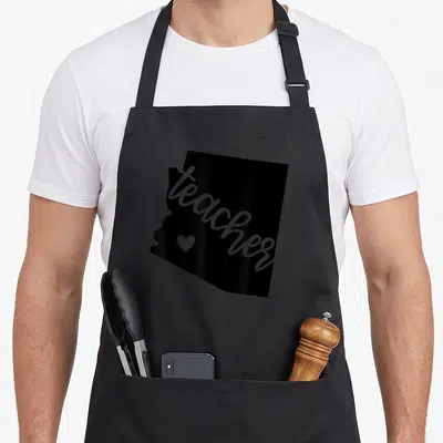 Arizona state teacher apron - Black Arizona map silhouette with grey diagonal teacher text and small heart icon — shown on a black cotton canvas apron against a white background