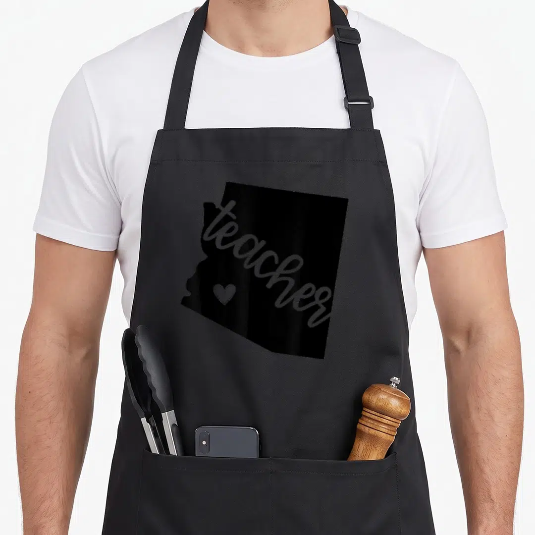 Arizona state teacher apron - Black Arizona map silhouette with grey diagonal teacher text and small heart icon — shown on a black cotton canvas apron against a white background