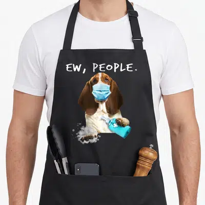Basset face apron - Basset hound in blue mask holding sanitizer bottle with bubbles and text — shown on a black cotton canvas apron against a white background