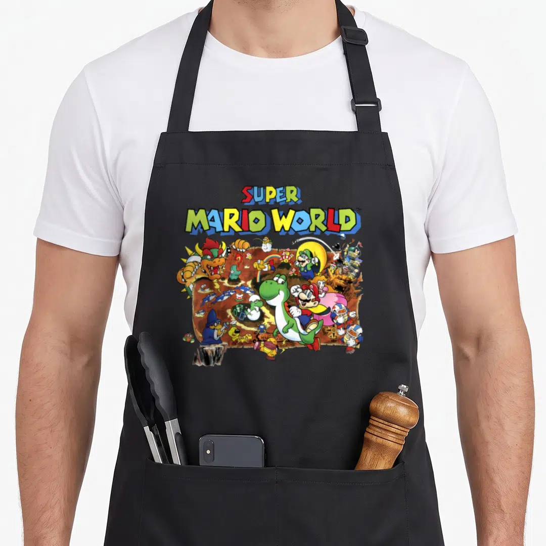 Map novelty apron - Super Mario World text and cartoon character cluster over map background — shown on a black cotton canvas apron against a white background