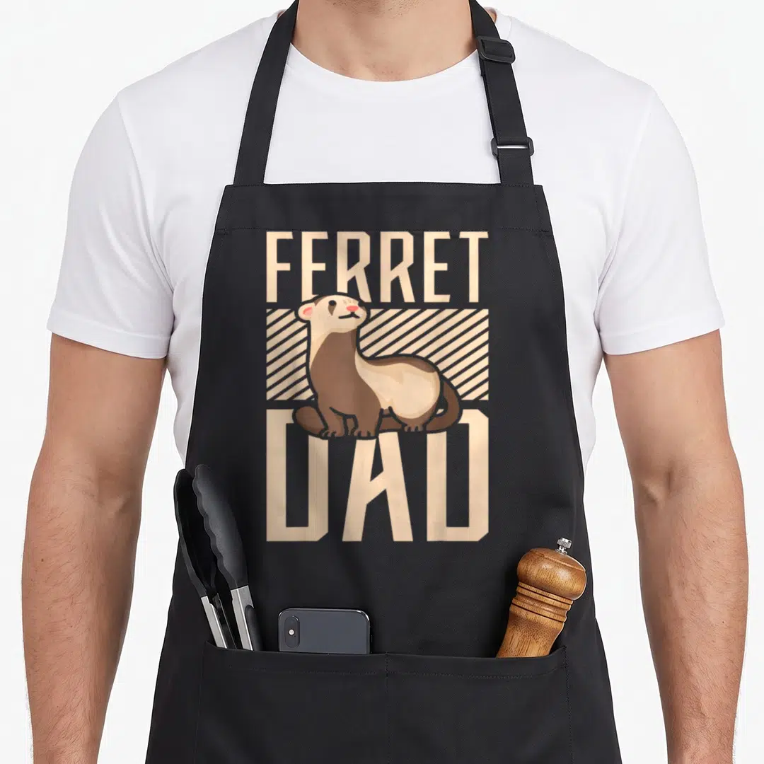 Vintage ferret dad apron - Cartoon brown and beige ferret between FERRET and DAD text on diagonal stripes — shown on a black cotton canvas apron against a white background