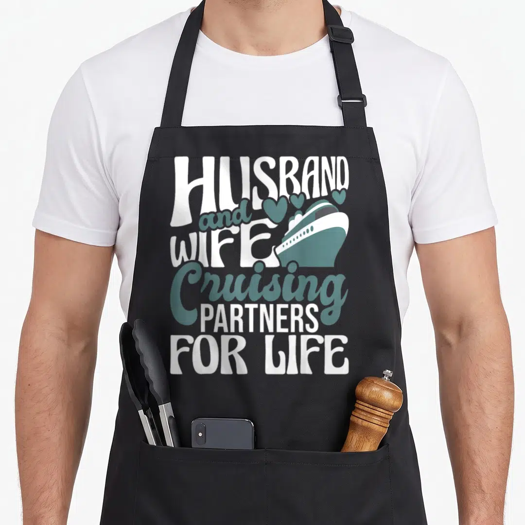 Partner cruiser husband wife aprons - Stacked text reading Husband Wife Cruising Partners For Life with a teal cruise — shown on a black cotton canvas apron against a white background