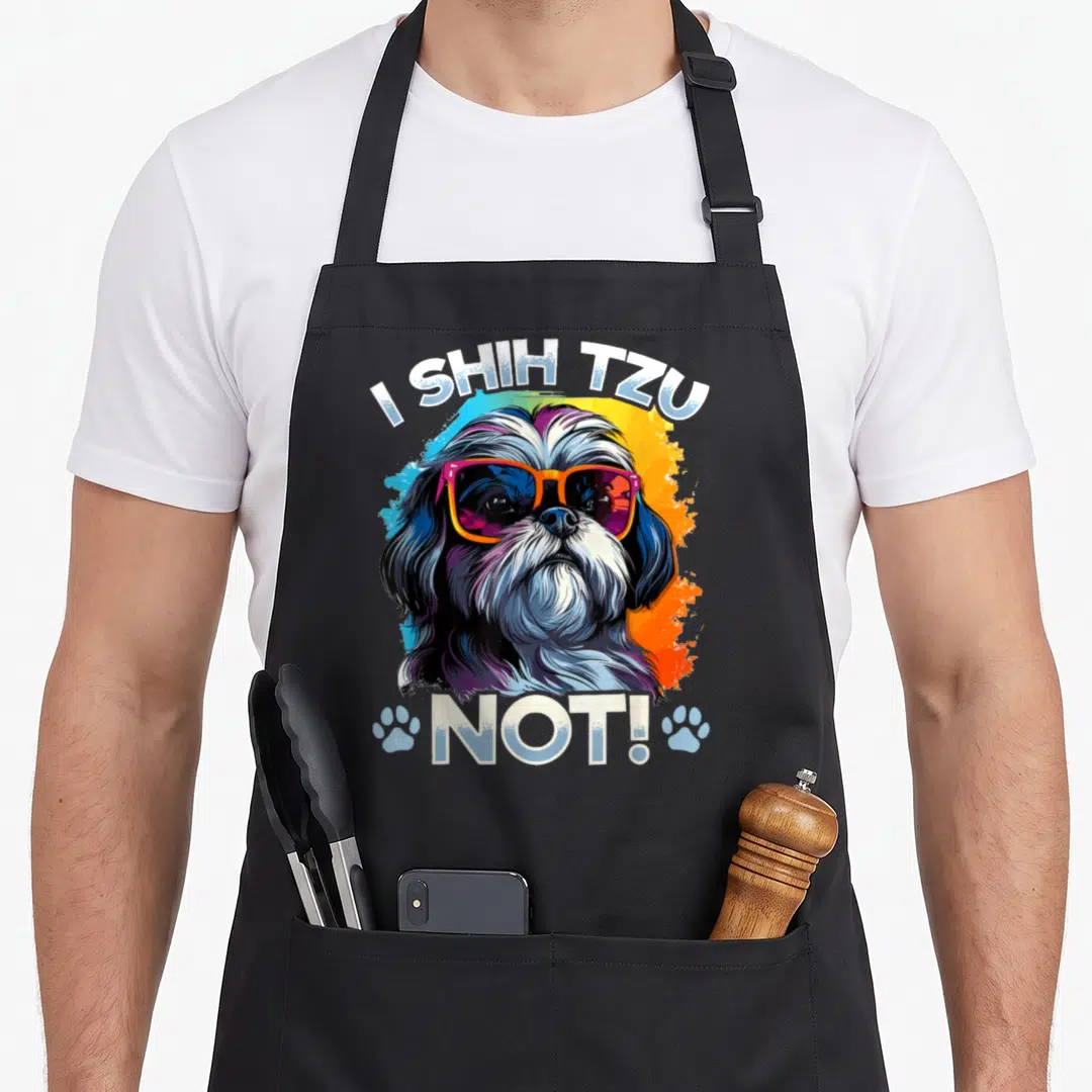 Tzu top dog aprons - Cartoon Shih Tzu with colorful glasses and text I Shih Tzu Not flanked by paw prints — shown on a black cotton canvas apron against a white background