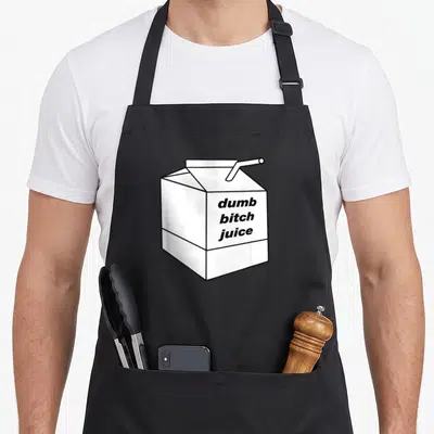 Dumb milk aprons - White juice box with straw and stacked black text dumb bitch juice line art — shown on a black cotton canvas apron against a white background