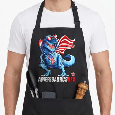 Amerisaurus 4th of july apron - Blue T-Rex with sunglasses cape and flag, AMERISAURUSREX text — shown on a black cotton canvas apron against a white background
