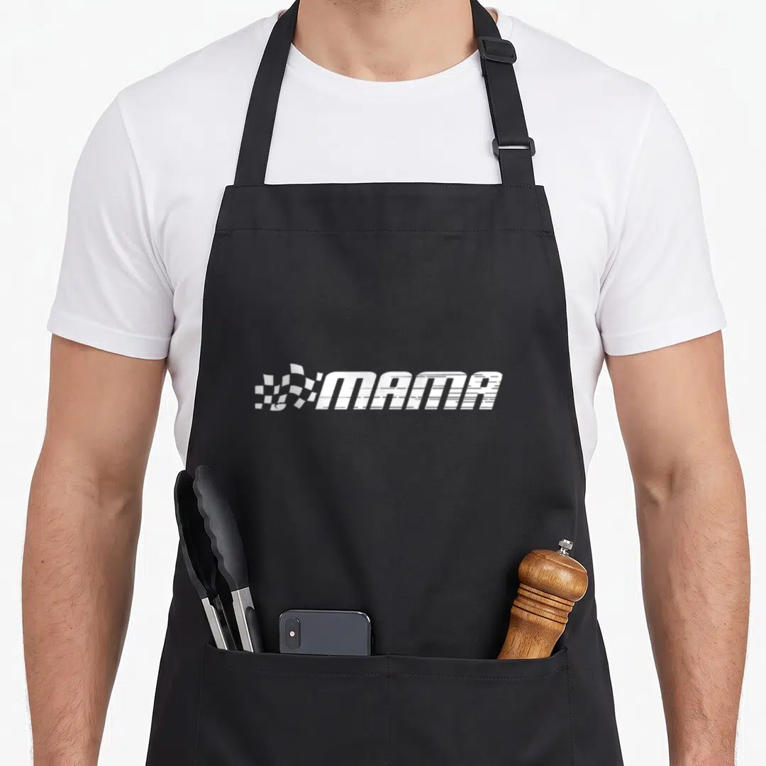 Mama car apron - White MAMA text with checkered flag in speed font on grey background — shown on a black cotton canvas apron against a white background