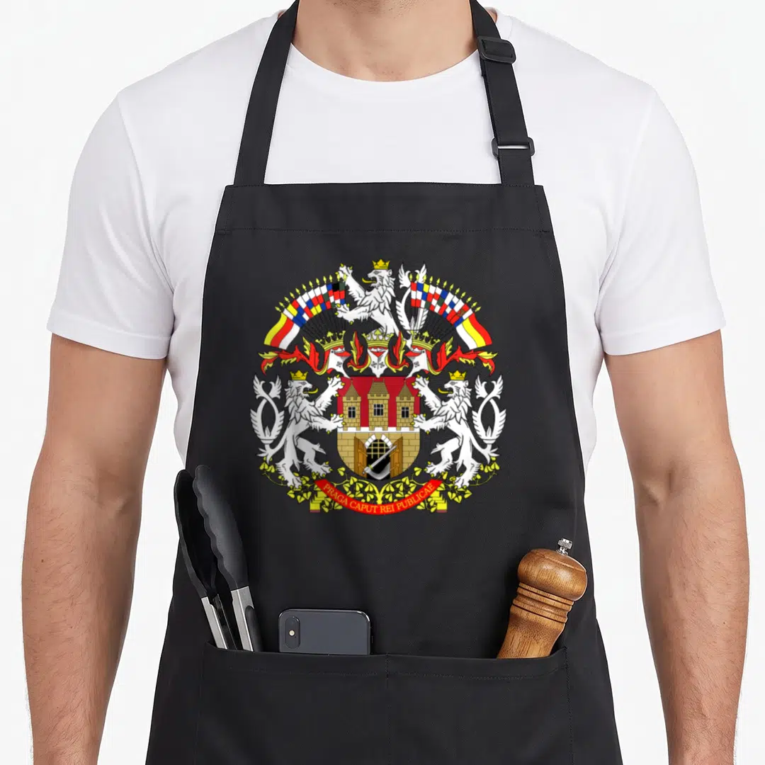 Praha czech apron - Coat of arms with three lions, castle shield, arched flags, red ribbon reading PRAGA CAPUT REI — shown on a black cotton canvas apron against a white background