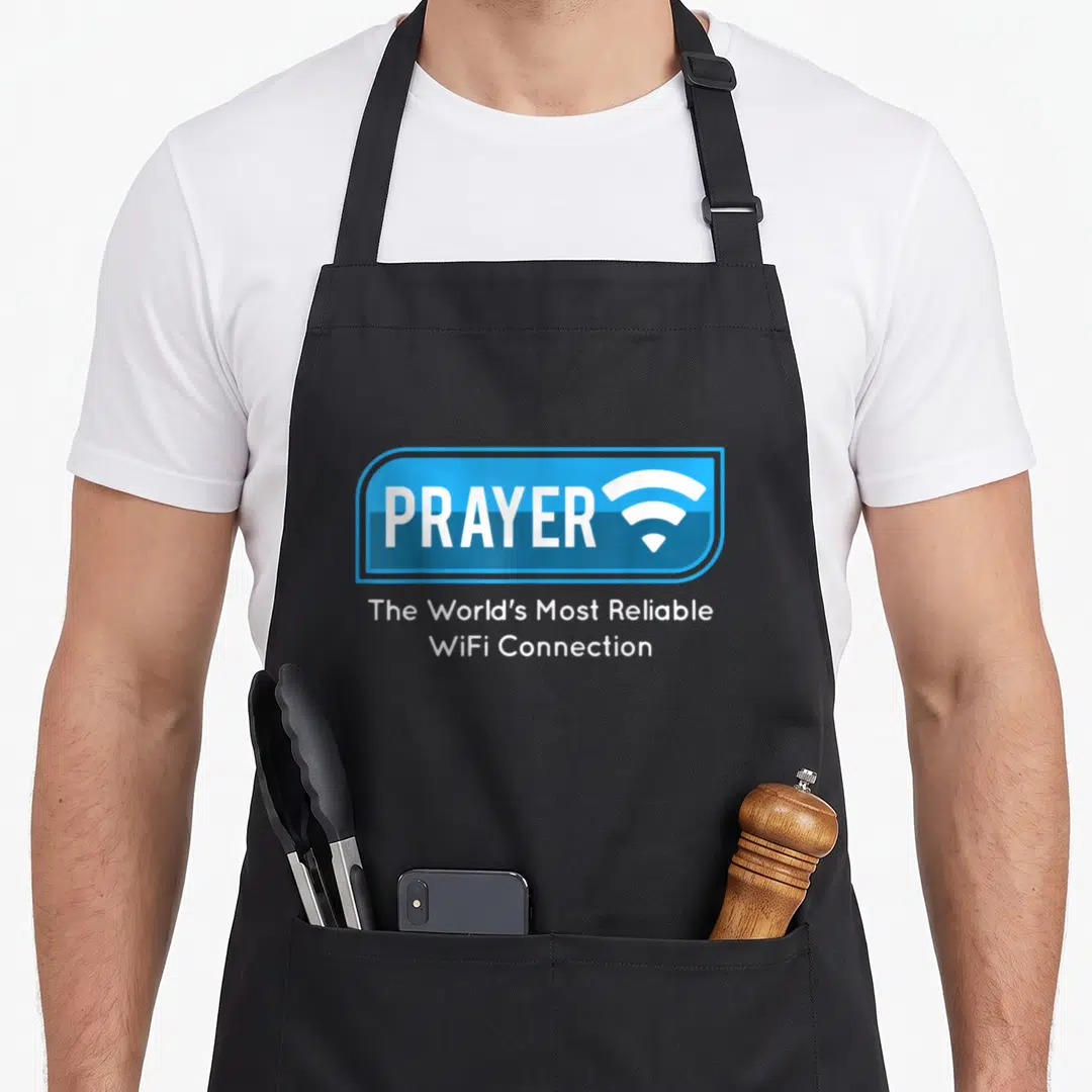 Christian catholic apron - Blue rectangle with PRAYER text and wifi symbol above reliable connection caption — shown on a black cotton canvas apron against a white background