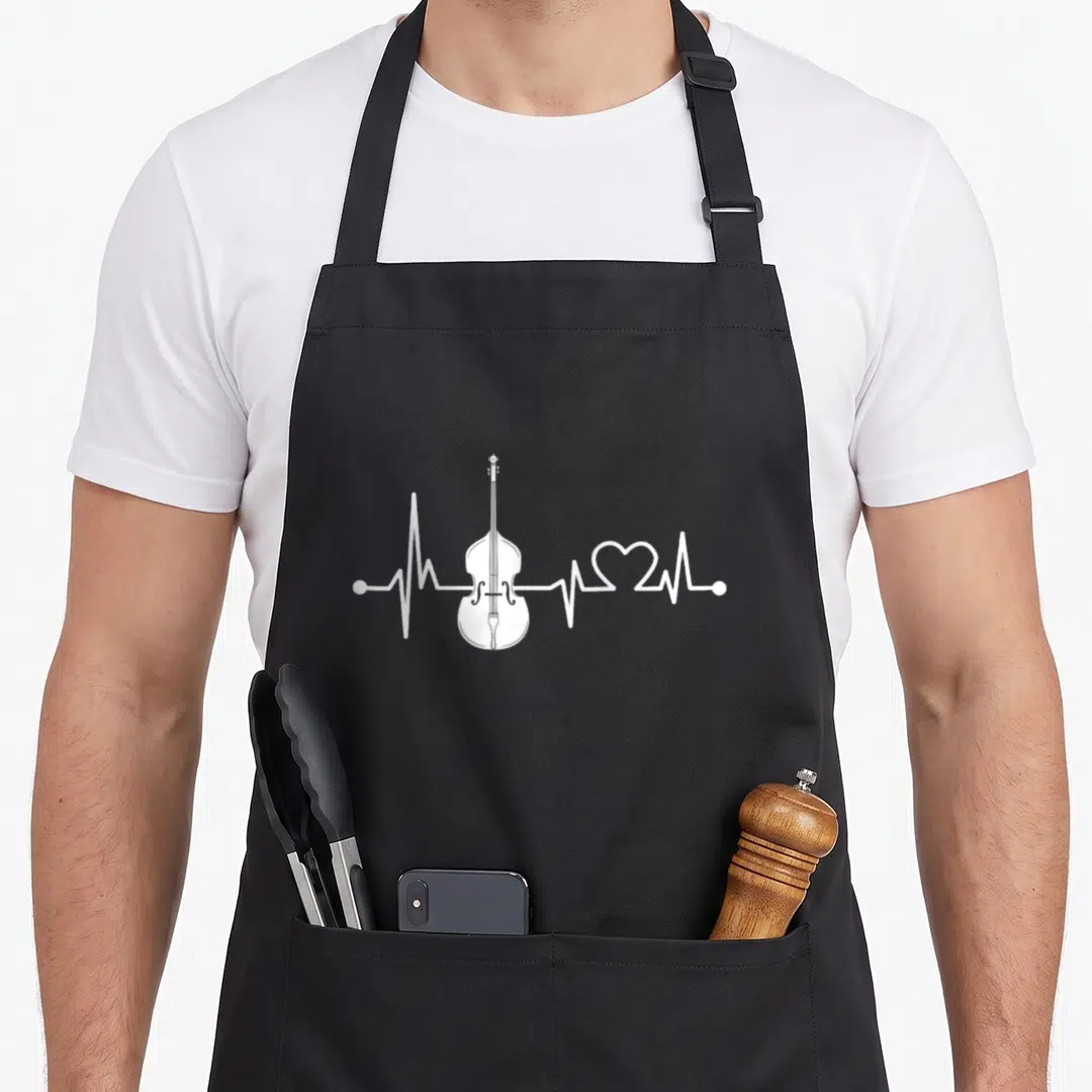 Heartbeat double apron - White cello integrated into a horizontal heartbeat line with a heart symbol on black fabric — shown on a black cotton canvas apron against a white background