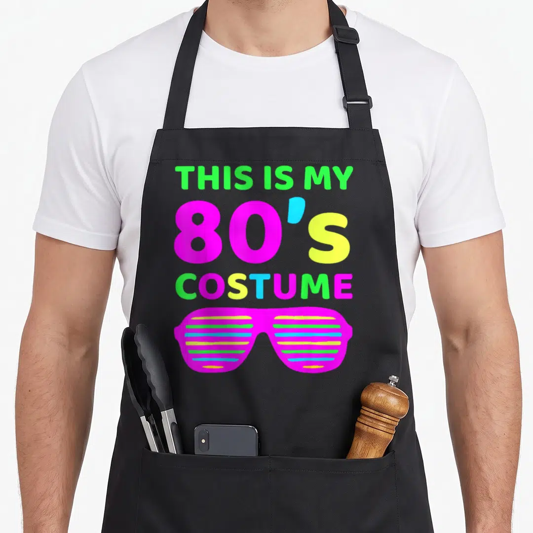 Outfit eighty 80s apron - Stacked text THIS IS MY 80'S COSTUME above magenta shutter shades — shown on a black cotton canvas apron against a white background
