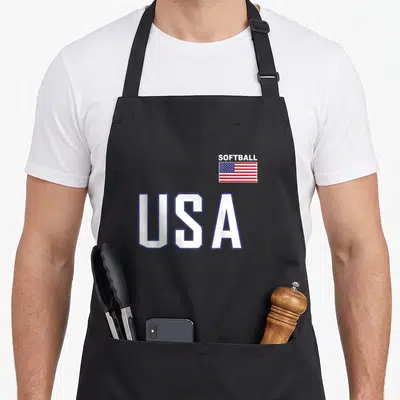 Flag practice apron - SOFTBALL USA text with small American flag graphic in white blue and red — shown on a black cotton canvas apron against a white background