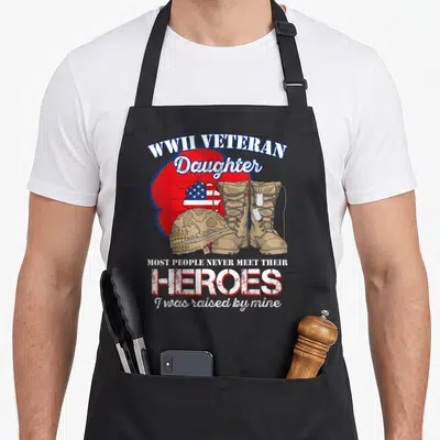 Wwii people meet apron - Text and military boots helmet flag on red poppy background — shown on a black cotton canvas apron against a white background