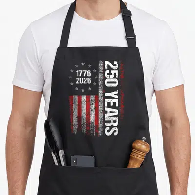 250th independence day apron - Distressed red and white USA flag with 1776 2026 and 250 YEARS text — shown on a black cotton canvas apron against a white background