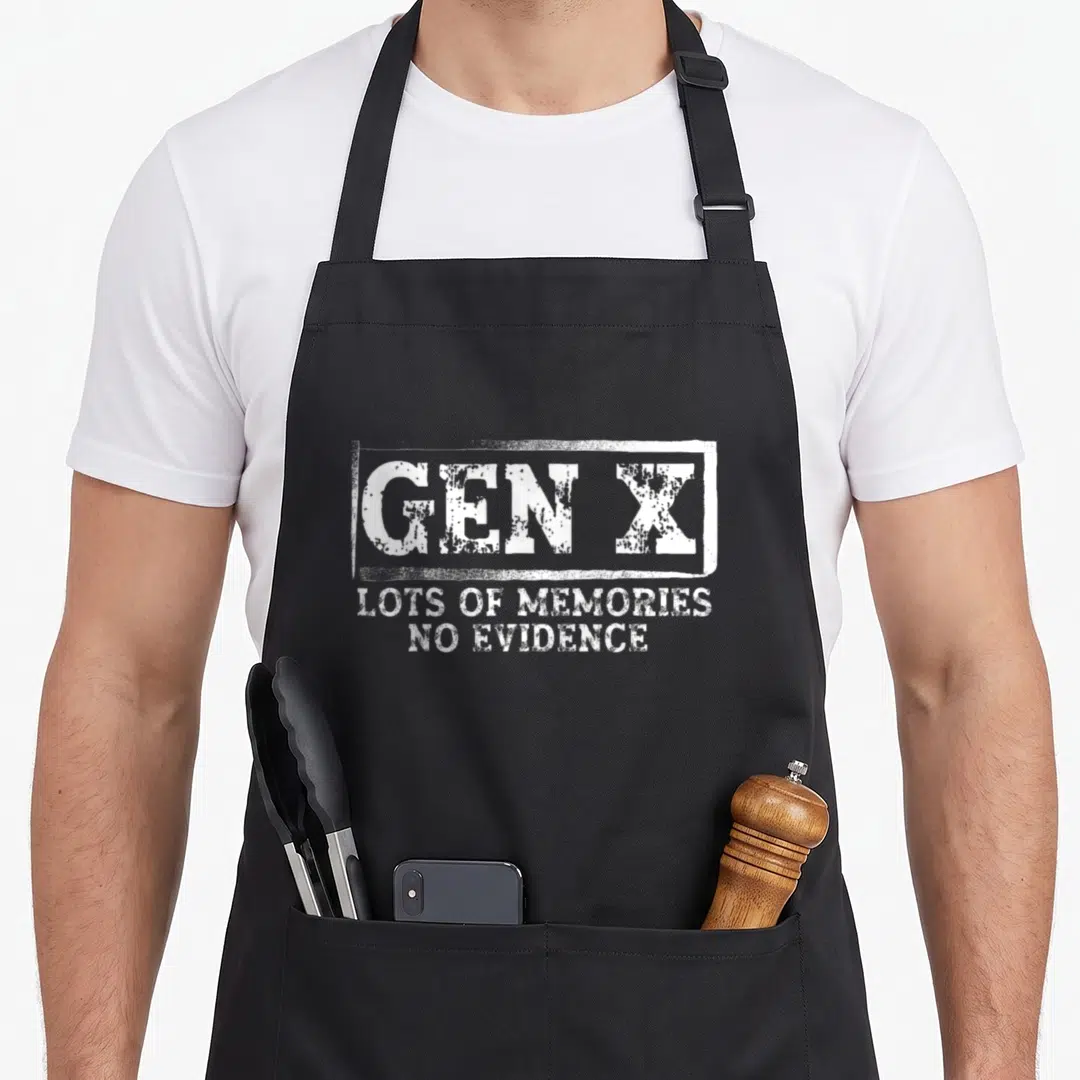 Gen sarcastic apron - White distressed text reading Gen X lots of memories no evidence on black fabric — shown on a black cotton canvas apron against a white background