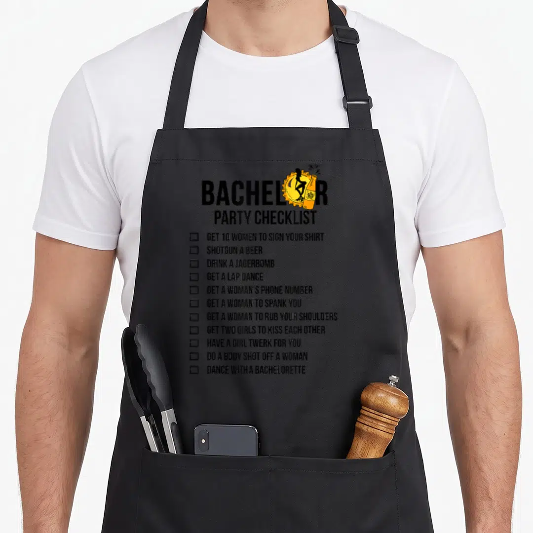 Bachelor have better apron - Black checklist with orange beer bottle graphic listing party activities — shown on a black cotton canvas apron against a white background