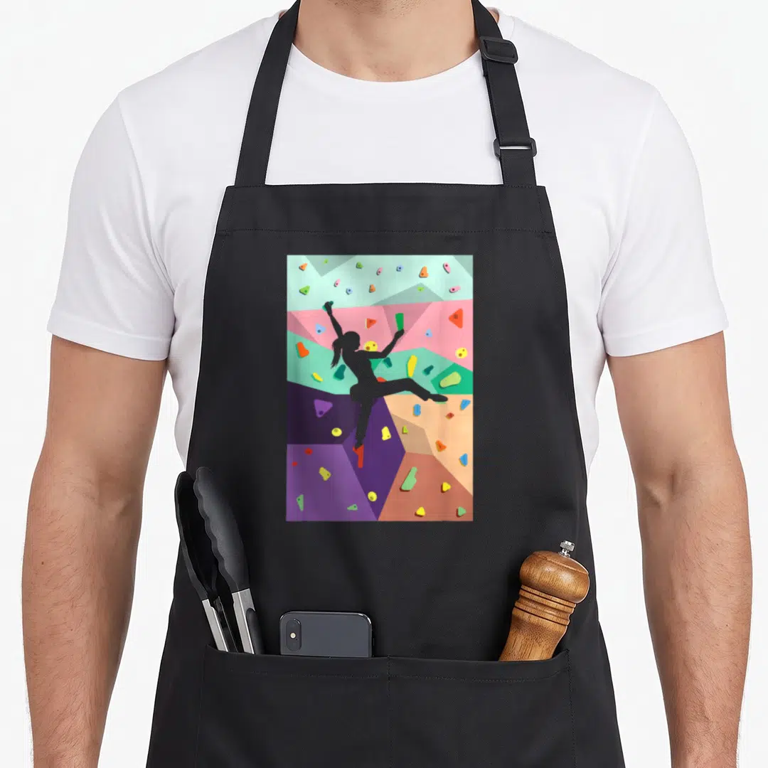 Wall climbing apron - Grey climber silhouette on geometric wall with pink, blue, green, purple, orange holds — shown on a black cotton canvas apron against a white background