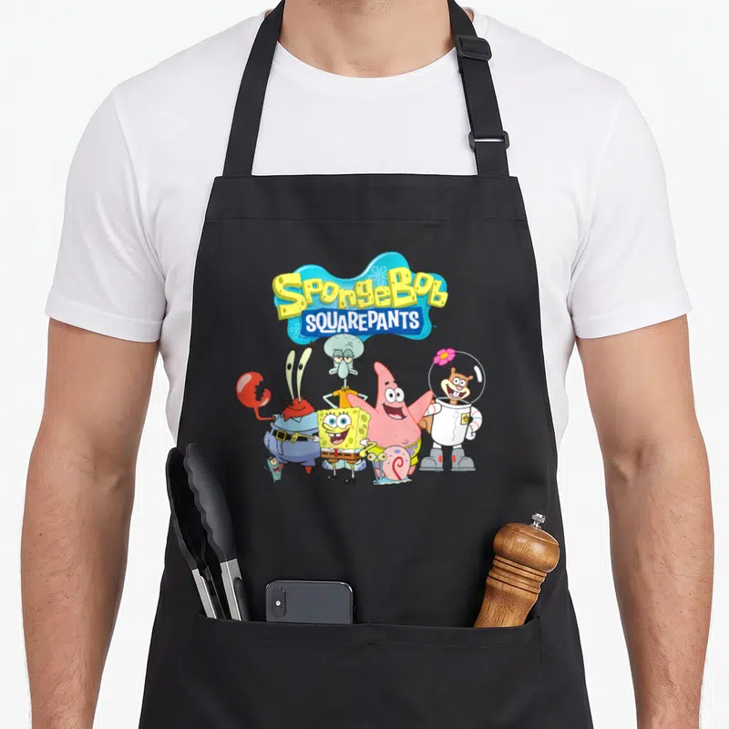 Squarepant best friend aprons - SQUAREPANTS logo above yellow blue pink red cartoon characters standing in a group — shown on a black cotton canvas apron against a white background
