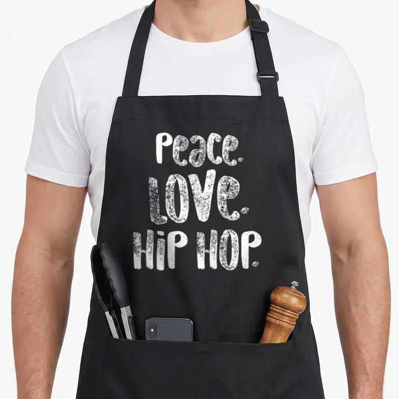Peace hip aprons - White stacked text reading PEACE. LOVE. HIP HOP. on grey background — shown on a black cotton canvas apron against a white background