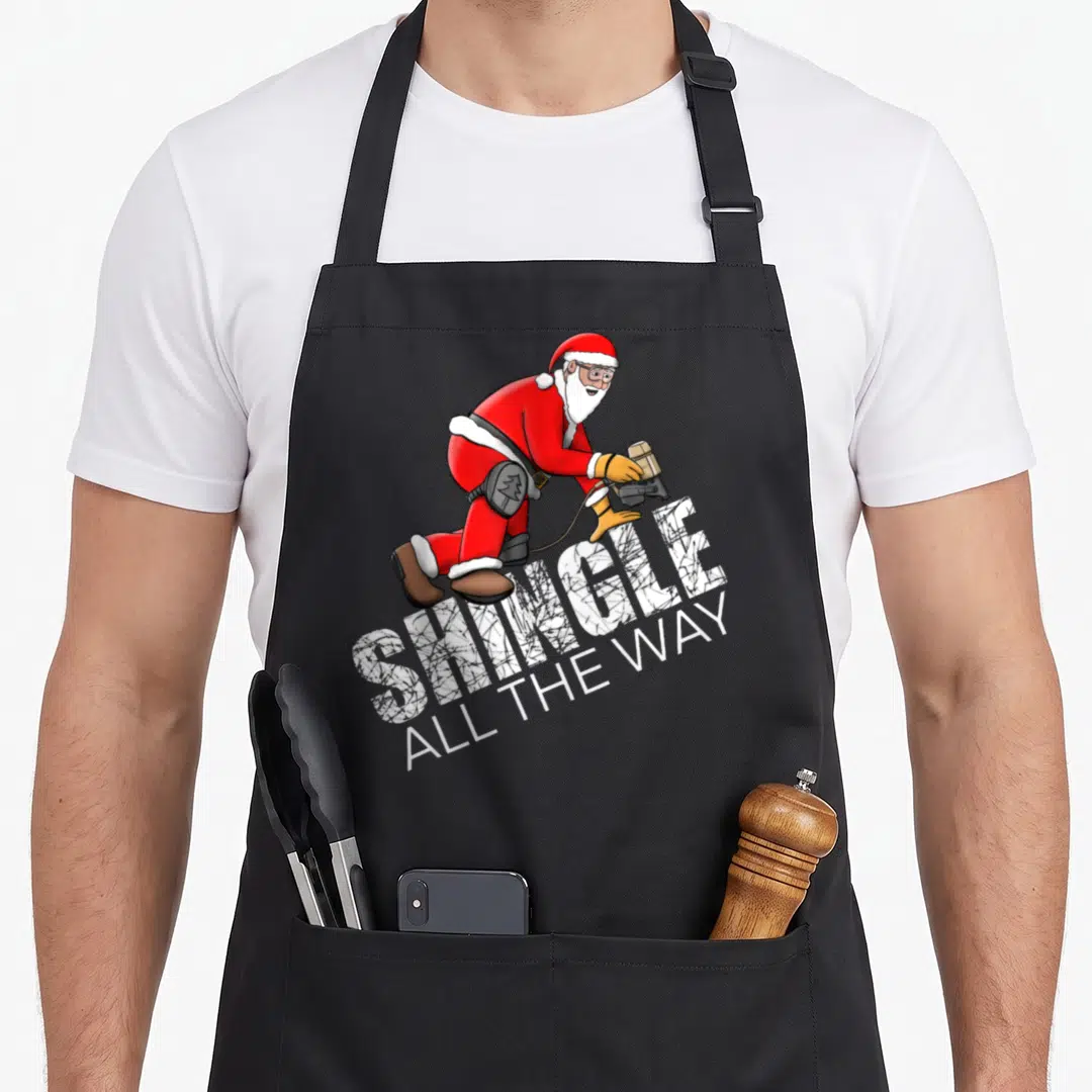Roofing christmas apron - Santa Claus using nail gun with Shingle All the Way text — shown on a black cotton canvas apron against a white background