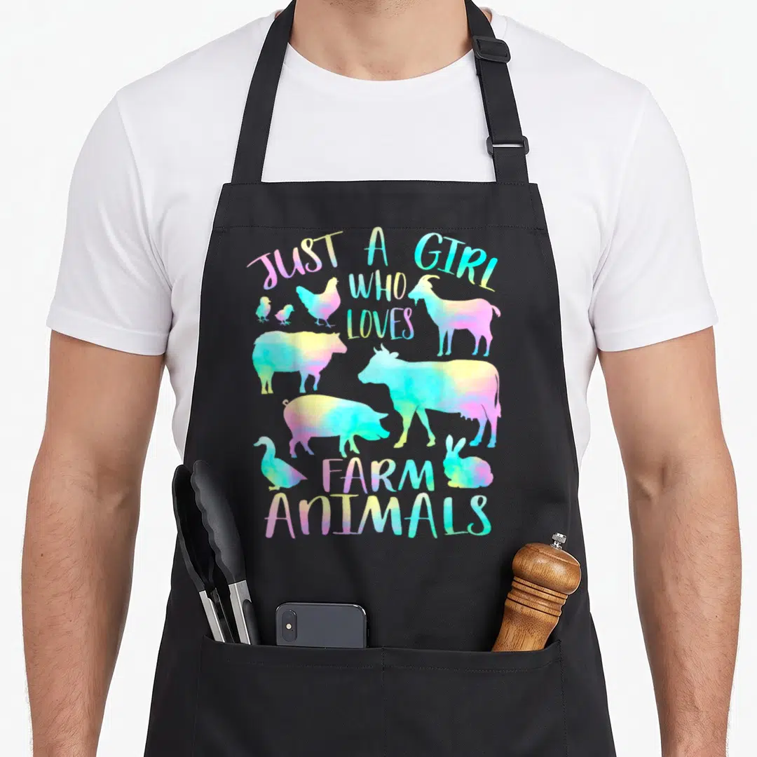 Animal cow farm aprons - Rainbow watercolor silhouettes of cows, pigs, goats, and text reading Just a Girl Who Loves — shown on a black cotton canvas apron against a white background