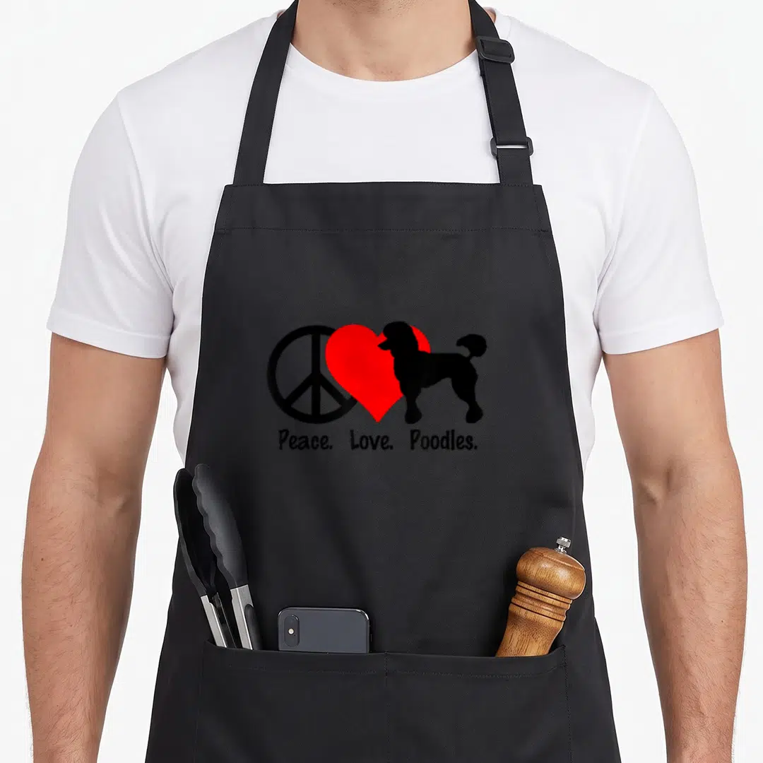 Peace standard size of apron - Black peace symbol, red heart, and poodle silhouette with centered text below — shown on a black cotton canvas apron against a white background