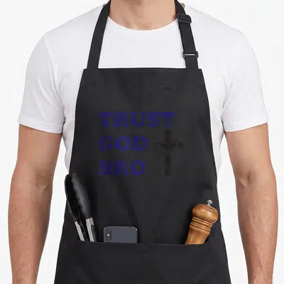 Trust youth pastor apron - Distressed blue TRUST GOD BRO text beside a black cross wrapped in a crown of thorns — shown on a black cotton canvas apron against a white background