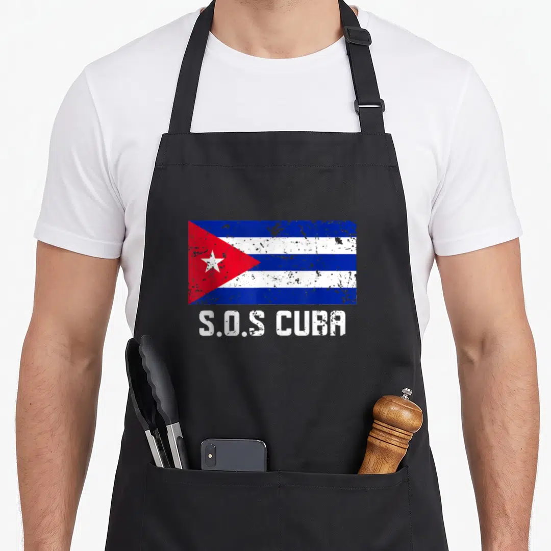 Sos cuba apron - Distressed Cuban flag with S.O.S CUBA text below in white block letters — shown on a black cotton canvas apron against a white background