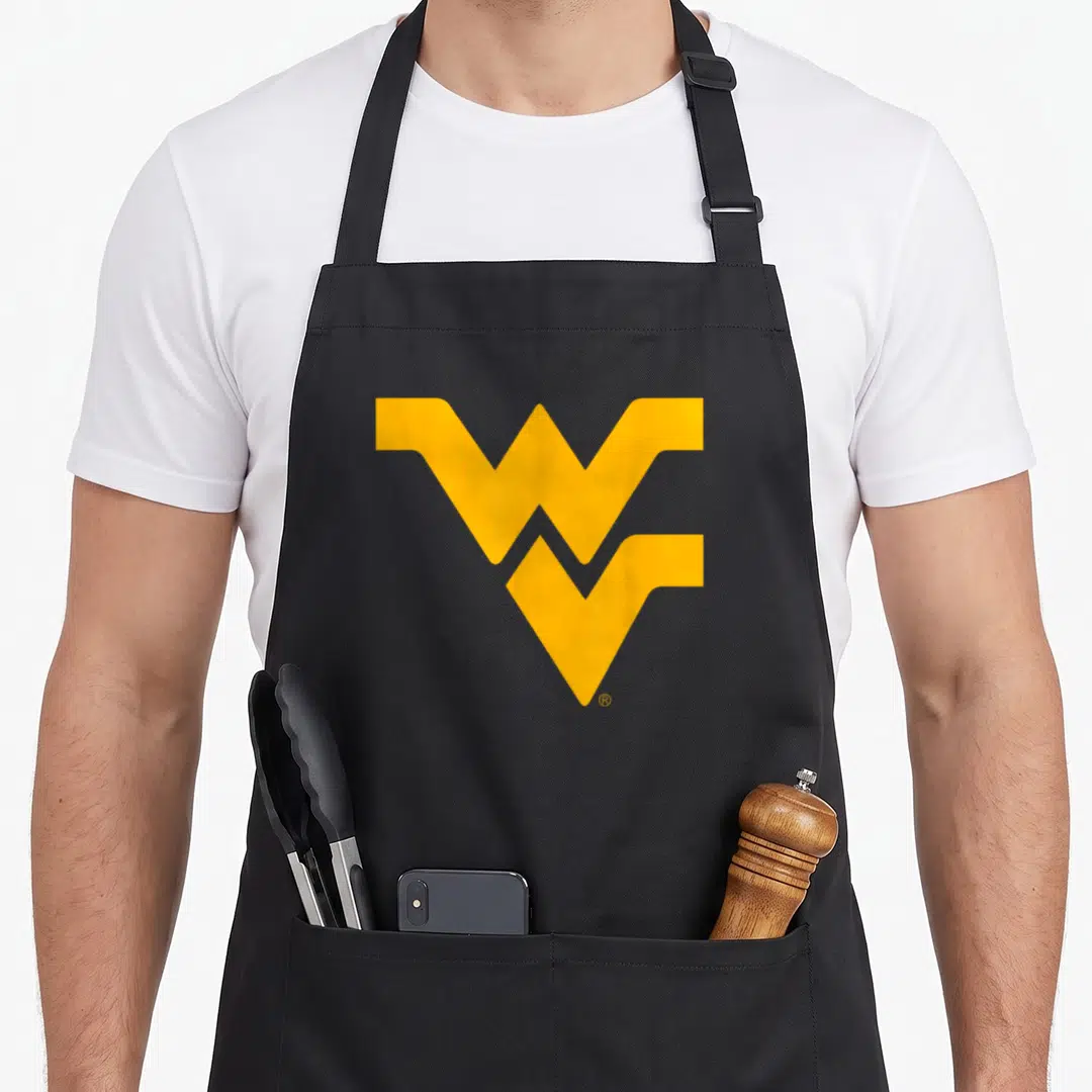 Mountaineer virginia girl apron - Gold interlocking WV logo centered on grey background — shown on a black cotton canvas apron against a white background