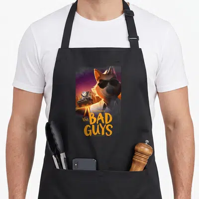 Selfie mr apron - Wolf wearing sunglasses next to a car with the text the BAD GUYS below — shown on a black cotton canvas apron against a white background